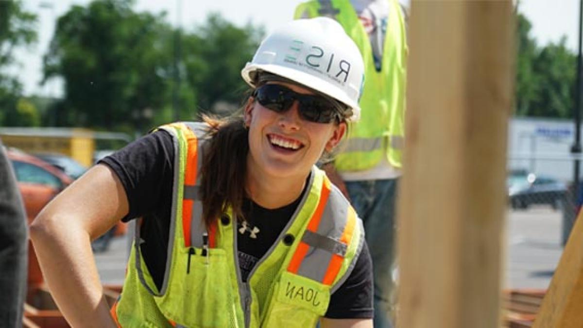 DU engineering student with hardhat and vest on job site